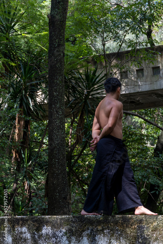 mexican man doing yoga and stretching in the forest, mexico © rodrigo