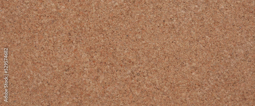 Cork board background is used for design work.