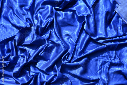 Dark blue silk satin fabric. Elegant fabric background.