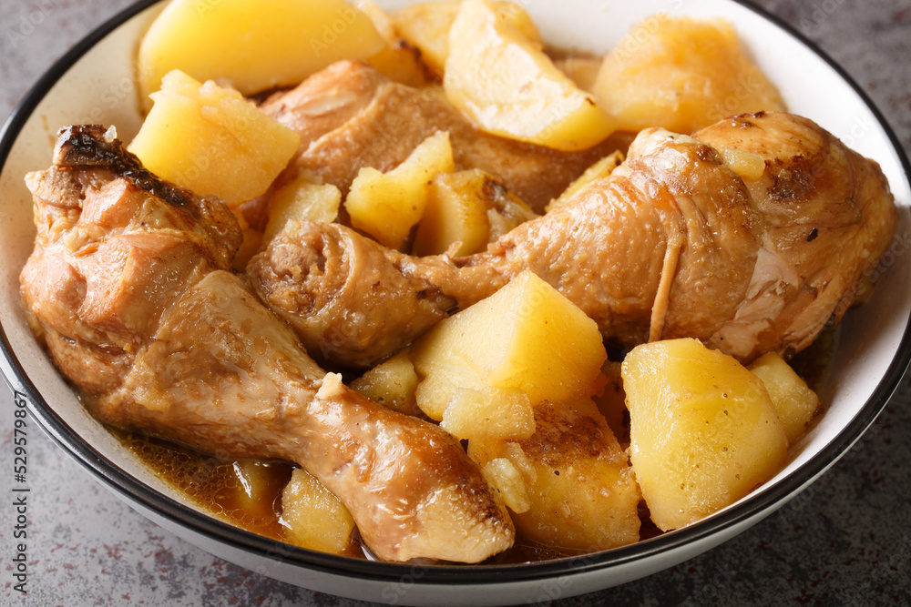 Indonesian semur ayam is a delicious way to prepare chicken and potatoes in a blend of spices, nutmeg, and sweet soy sauce closeup on the bowl on the table. Horizontal Indonesian semur ayam is a delicious way to prepare chicken and potatoes in a blend of spices, nutmeg, and sweet soy sauce closeup on the bowl on the table. Horizontal