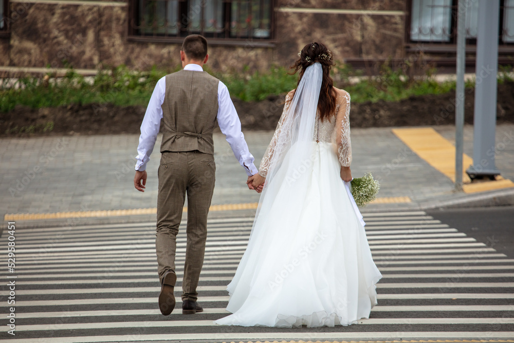 Bride and groom at a pedestrian crossing. Bride and groom at a pedestrian crossing.