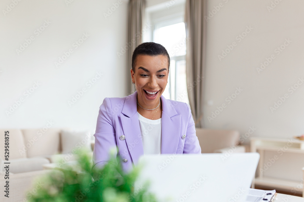 Beautiful woman freelancer noting information for planning project doing remote job via laptop computer. woman laughing while reading email on modern laptop device . Beautiful woman freelancer noting information for planning project doing remote job via laptop computer. woman laughing while reading email on modern laptop device .
