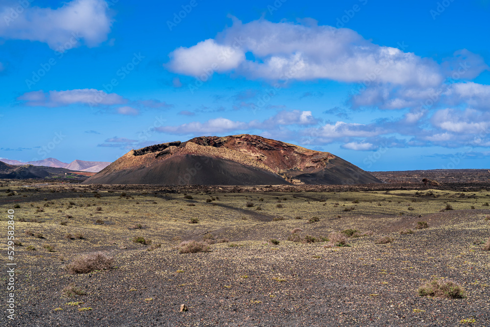 View of the incredible El Cuervo volcano, centered on the scene. Photography made in Lanzarote, Canary Islands, Spain.