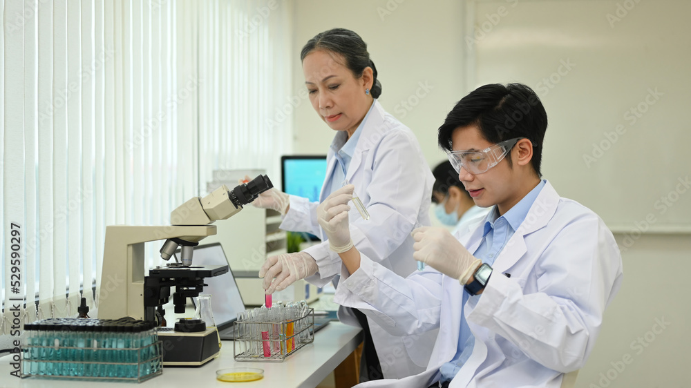 Professional scientist team conducting experiment in laboratory. Medicine and science research concepts Professional scientist team conducting experiment in laboratory. Medicine and science research concepts