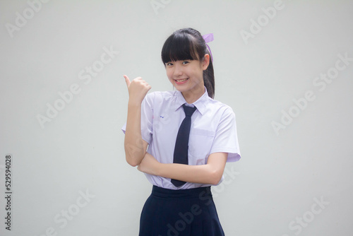 Fotografija Portrait of thai Junior high school student uniform beautiful girl pointing
