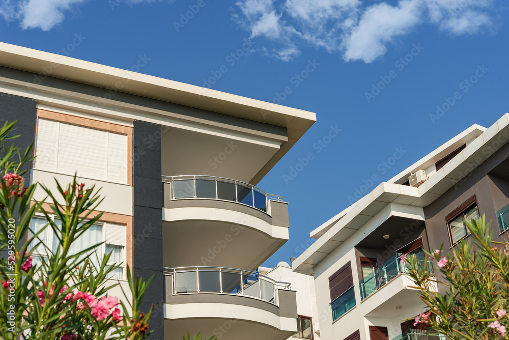 Image of the exterior of a residential building against a blue sky.
