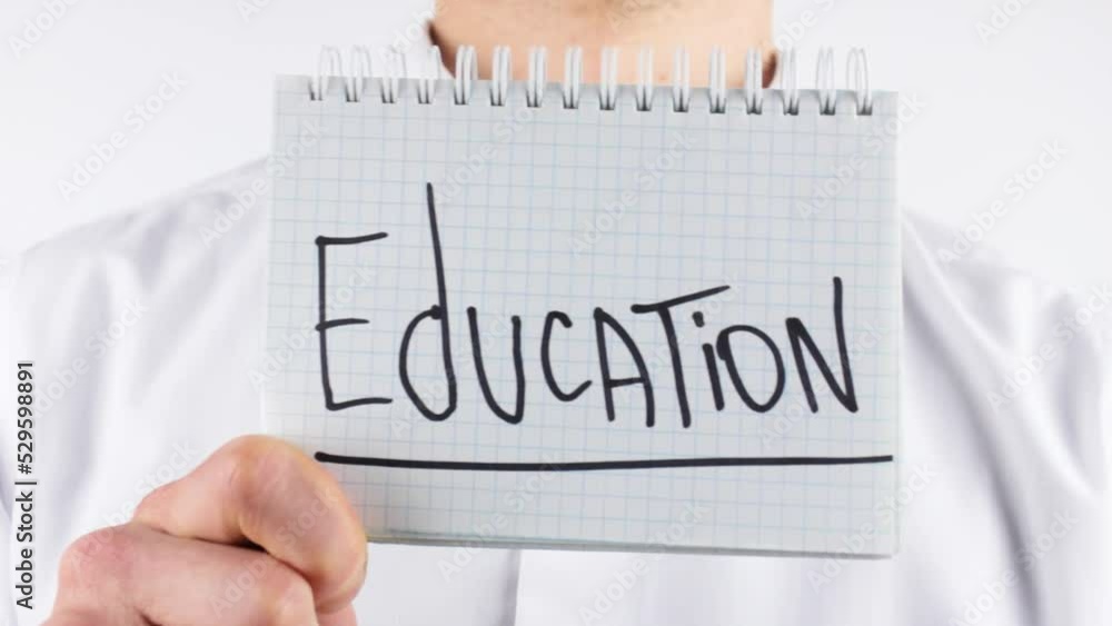 A man is holding a notepad with the word Education. Getting an education, a profession. Completion of online courses, training of specialists, gaining knowledge. A man is holding a notepad with the word Education. Getting an education, a profession. Completion of online courses, training of specialists, gaining knowledge.