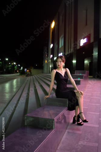 portrait of asian woman outdoors in neon light