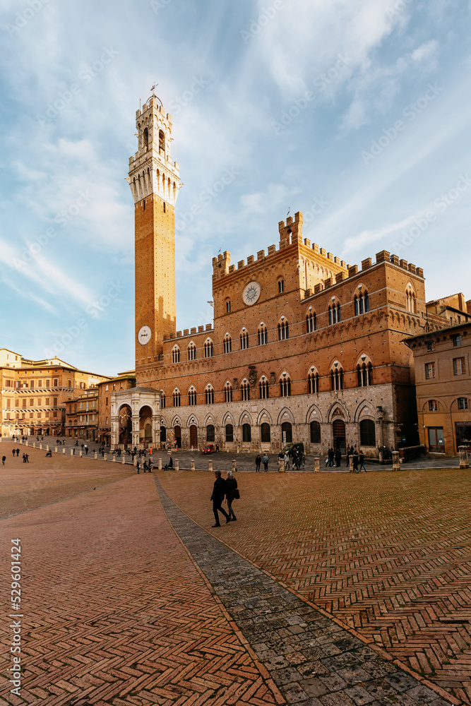 The high tower of Torre del Mangia in Piazza del Campo. Siena. Italy