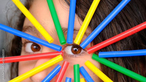 girl looking through colored sticks