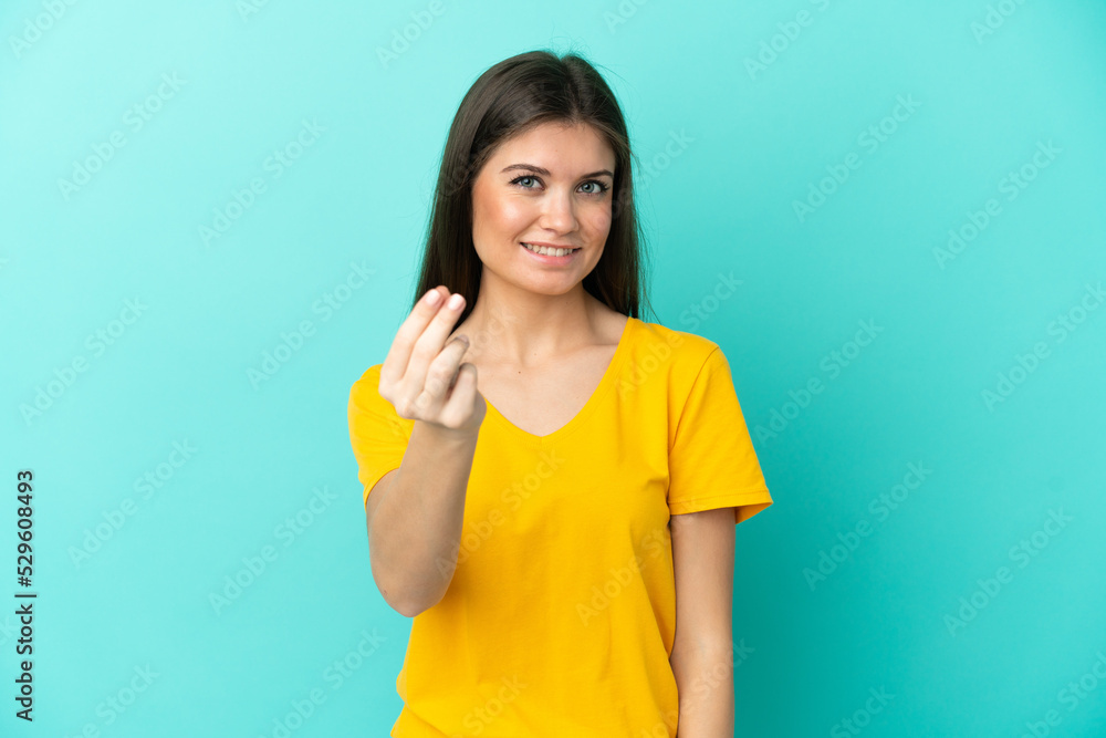 Young caucasian woman isolated on blue background making money gesture Young caucasian woman isolated on blue background making money gesture