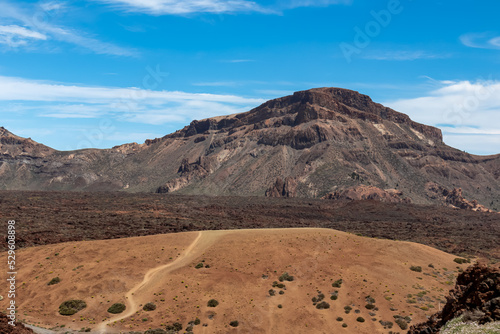 Panoramic view on Guajara  Roque de la Grieta and Montana Majua in volcano Mount El Teide National Park  Tenerife  Canary Islands  Spain  Europe. Volcanic barren desert landscape. Scenic hike trail