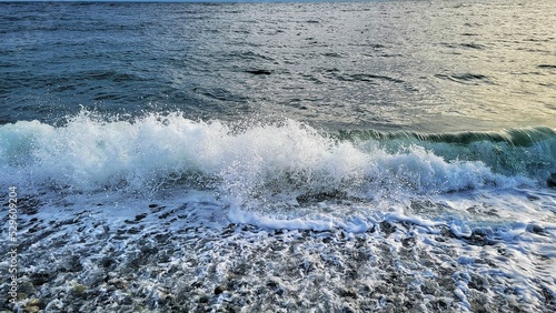 Beautiful view of a rocky beach with foamed waves