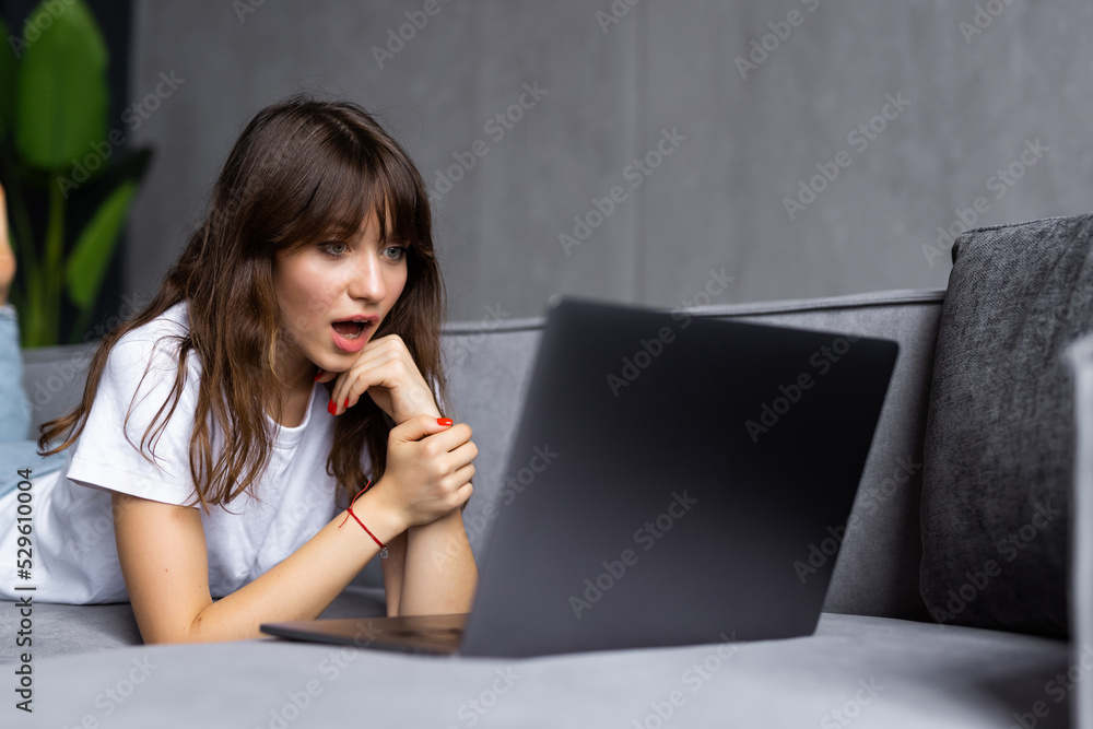 Young pretty woman working on laptop in loft apartment Young pretty woman working on laptop in loft apartment