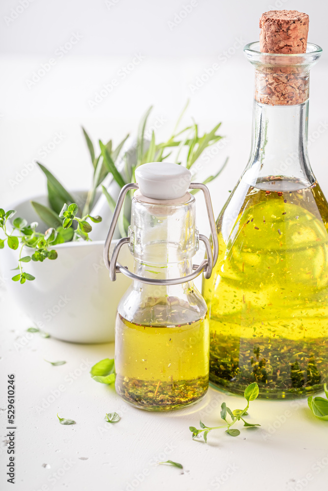 Healthy and fresh oil with fresh green plant leaves.