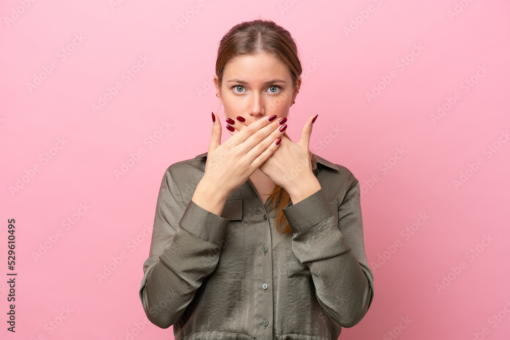 Young caucasian woman isolated on pink background covering mouth with hands Young caucasian woman isolated on pink background covering mouth with hands
