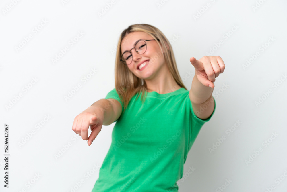 Fototapeta premium Young caucasian woman isolated on white background pointing front with happy expression