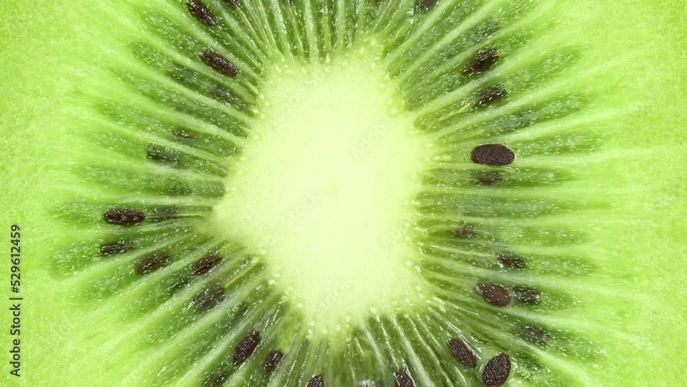 Kiwi fruit, cut inside rotating, turning, close-up macro, top view.
Kiwi fruit, cut inside rotating, turning, close-up macro, top view.