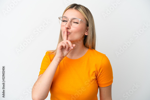 Young caucasian woman isolated on white background With glasses and doing silence gesture
