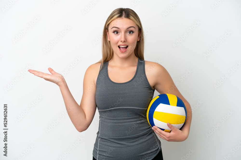Young caucasian woman playing volleyball isolated on white background with shocked facial expression Young caucasian woman playing volleyball isolated on white background with shocked facial expression