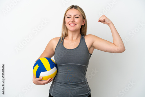 Young caucasian woman playing volleyball isolated on white background doing strong gesture
