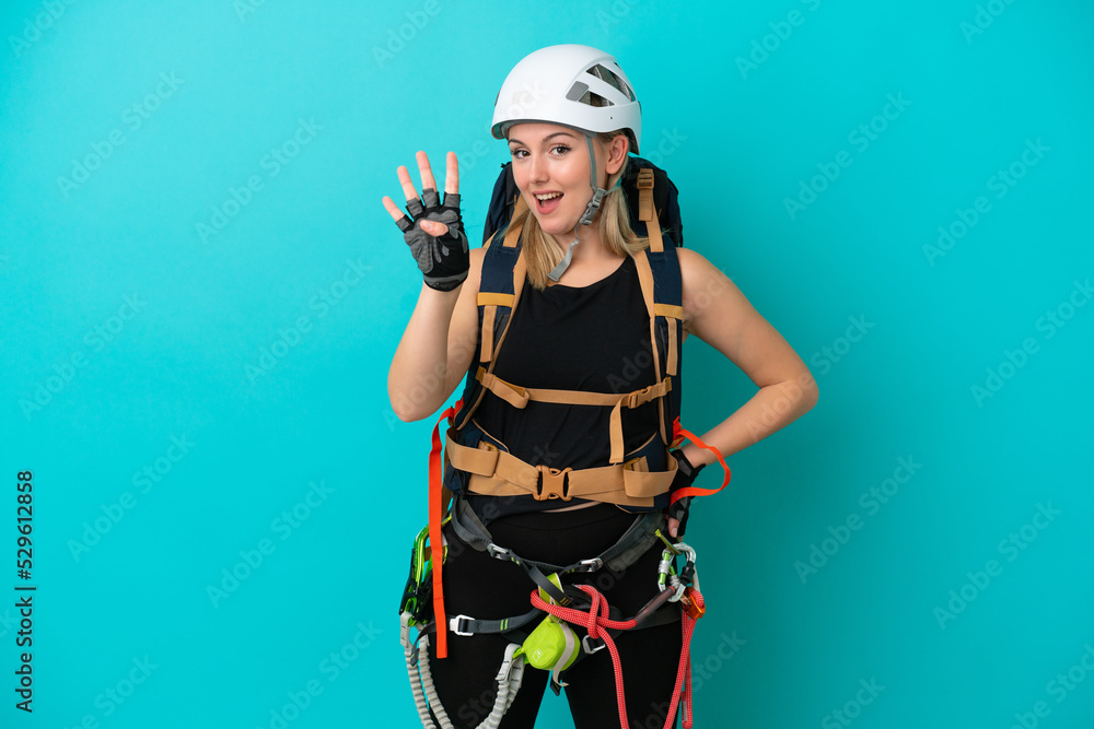 Young caucasian rock climber woman isolated on blue background happy and counting four with fingers Young caucasian rock climber woman isolated on blue background happy and counting four with fingers