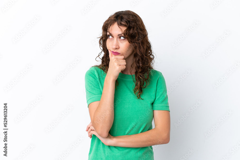 Young woman with curly hair isolated on white background having doubts and with confuse face expression Young woman with curly hair isolated on white background having doubts and with confuse face expression