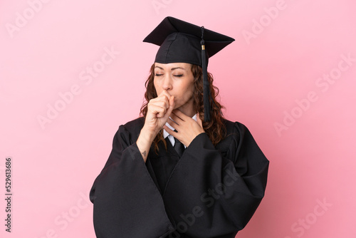 Young university graduate woman isolated on pink background is suffering with cough and feeling bad