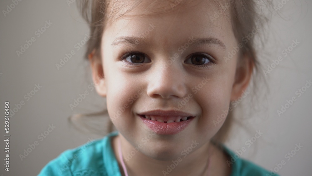 Portrait Funny Happy little kid close up happy preschool girl smiling child looking at camera pretty natural face. sincere emotions ashamed, embarrassed clean skin dermatology, pediatric dentistry Portrait Funny Happy little kid close up happy preschool girl smiling child looking at camera pretty natural face. sincere emotions ashamed, embarrassed clean skin dermatology, pediatric dentistry