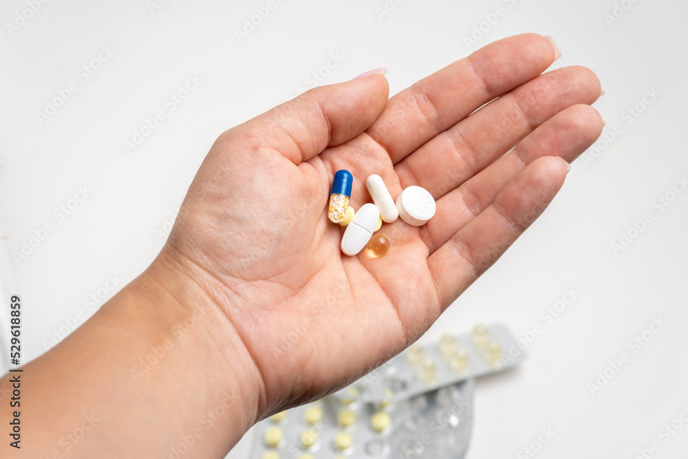 Handful of pills in hand