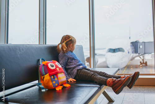 Photography Adorable little preschooler girl traveling by plane