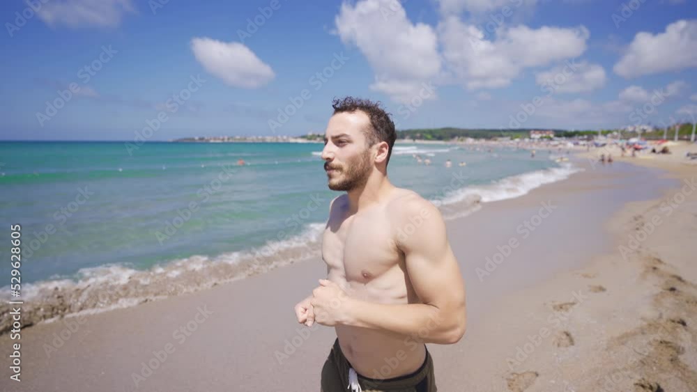 Young man jogging on the beach.
Muscular young man running on beach in summer day.
Young man jogging on the beach.
Muscular young man running on beach in summer day.