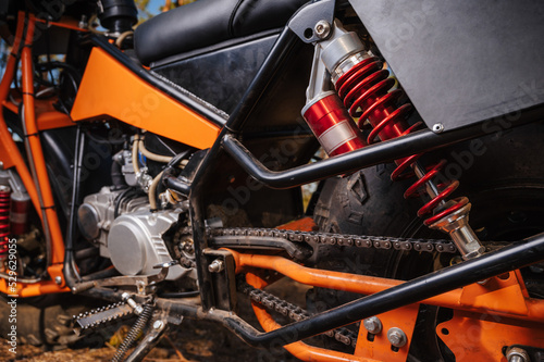 suspension with shock absorber and wheel close-up on a sports off-road custom motorcycle