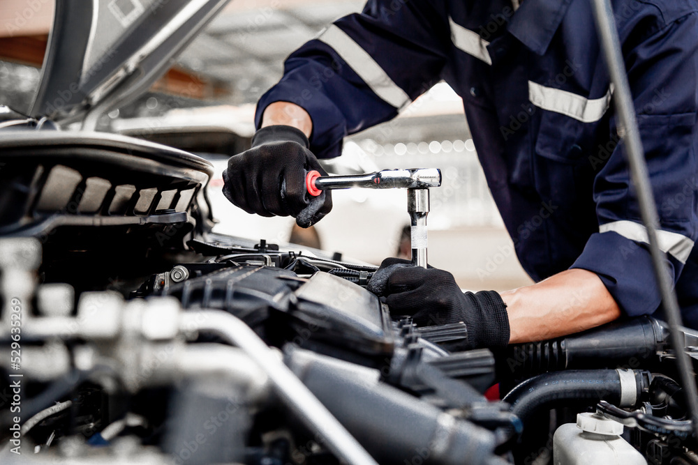 Car care maintenance and servicing, Close-up hand technician auto mechanic using the wrench to repairing change spare part car engine problem and insurance service support. Car care maintenance and servicing, Close-up hand technician auto mechanic using the wrench to repairing change spare part car engine problem and insurance service support.