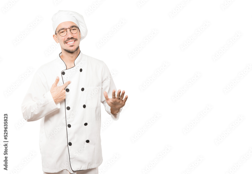 Friendly young chef doing a gesture of keep calm Friendly young chef doing a gesture of keep calm