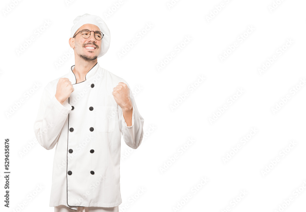 Upset young chef doing a competitive gesture Upset young chef doing a competitive gesture