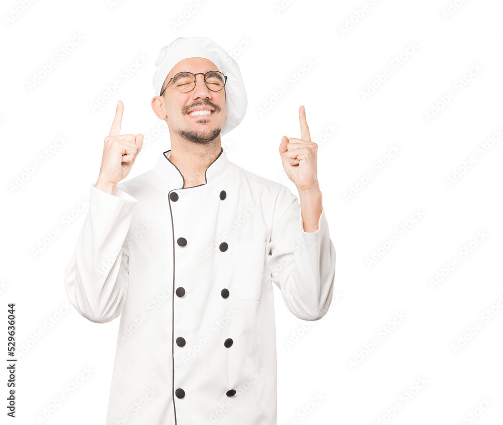 Competitive young chef making a gesture of celebration Competitive young chef making a gesture of celebration