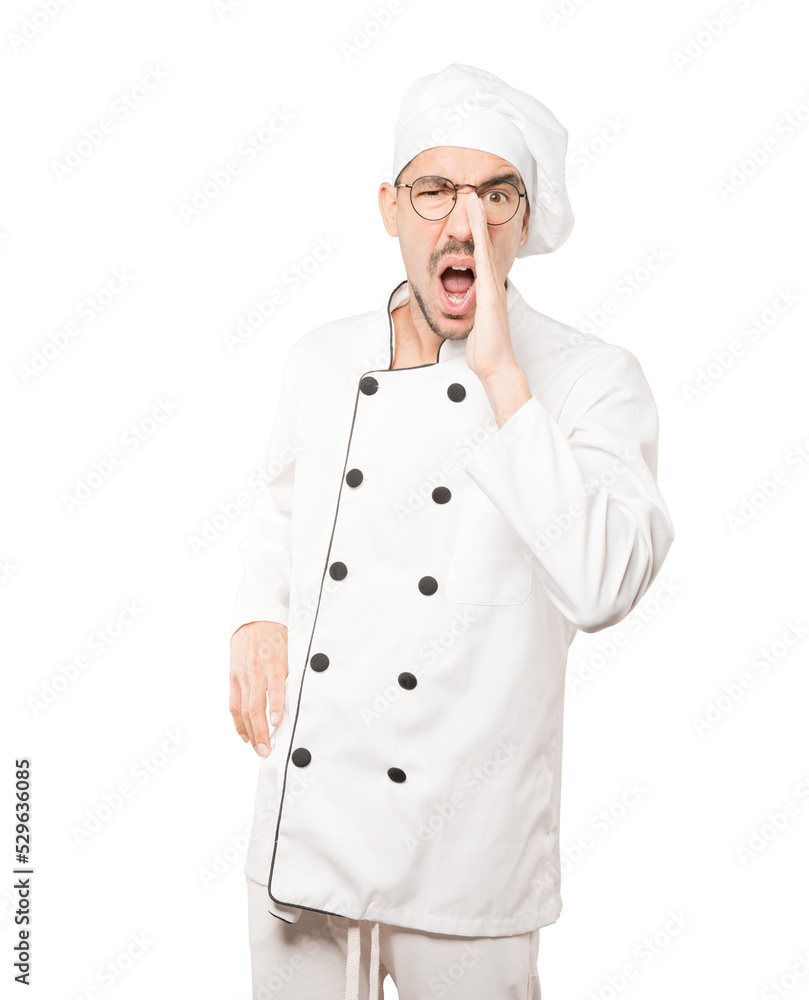 Angry young chef trying to say something strongly Angry young chef trying to say something strongly