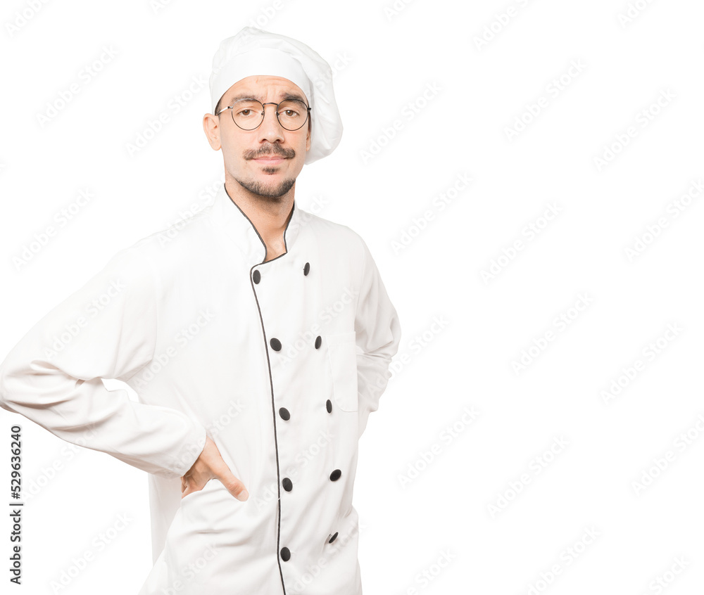 Hesitant young chef looking up gesture
