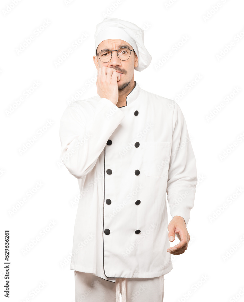 Crazy young chef making a nervous gesture Crazy young chef making a nervous gesture
