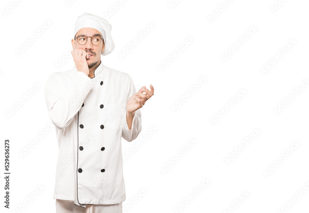 Crazy young chef making a nervous gesture Crazy young chef making a nervous gesture