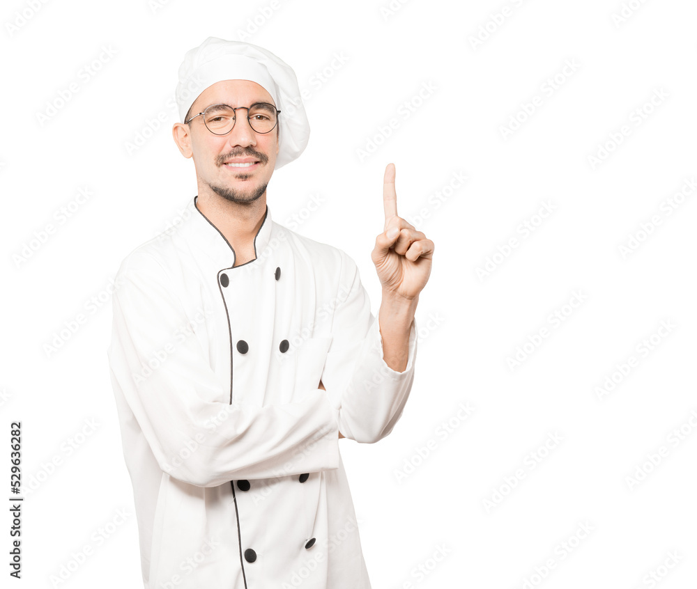 Young chef making a number one gesture