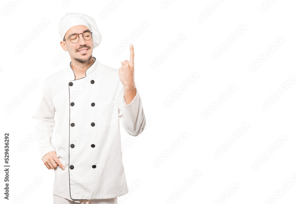 Young chef making a number one gesture