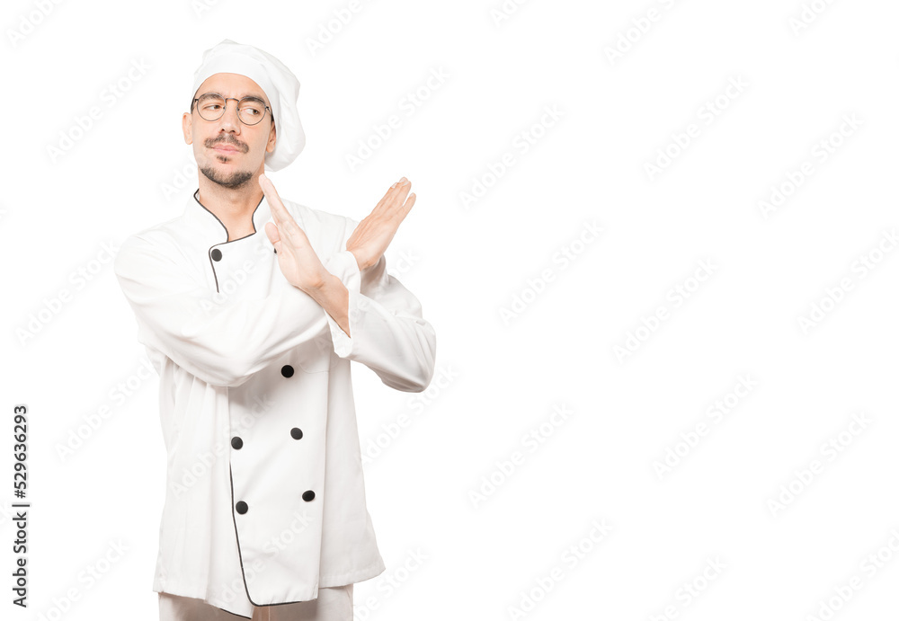 Young chef making a gesture of not crossing with the arms Young chef making a gesture of not crossing with the arms