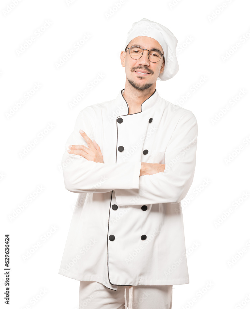Satisfied young chef with crossed arms gesture Satisfied young chef with crossed arms gesture
