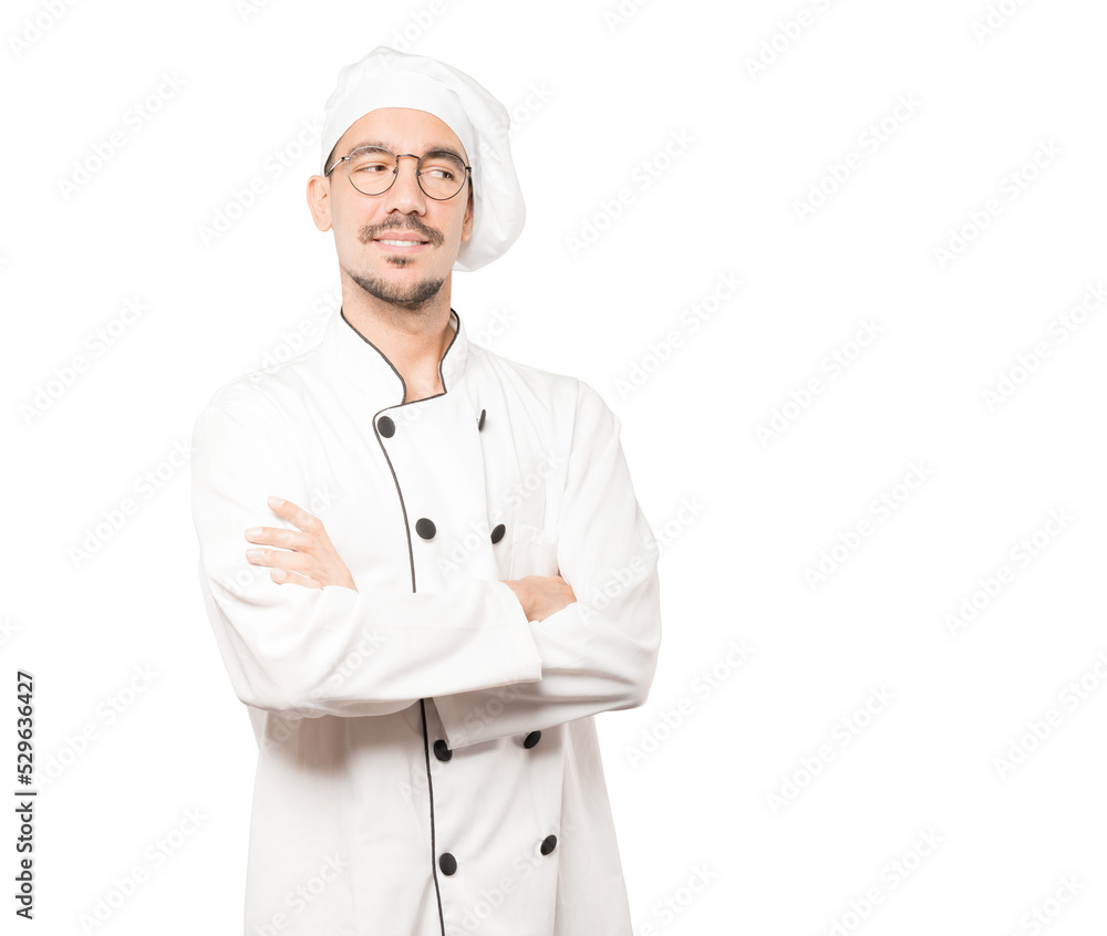 Satisfied young chef with crossed arms gesture Satisfied young chef with crossed arms gesture
