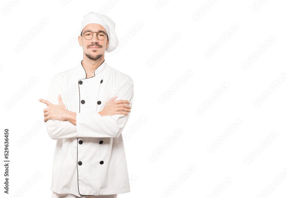 Satisfied young chef with crossed arms gesture Satisfied young chef with crossed arms gesture