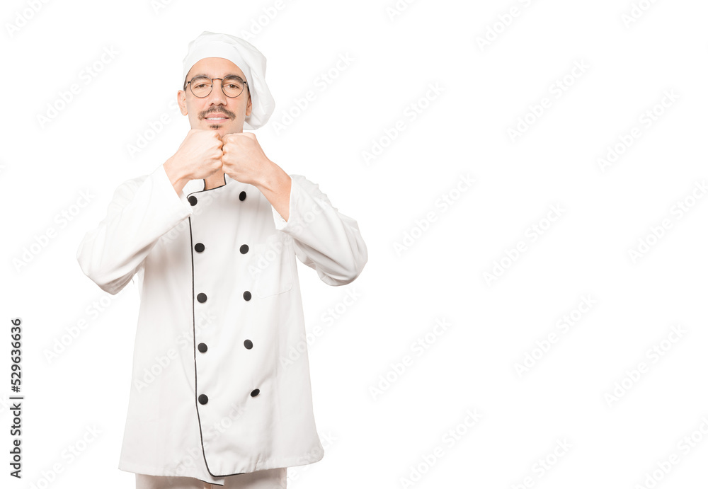 Young chef making a gesture of team work with his hands