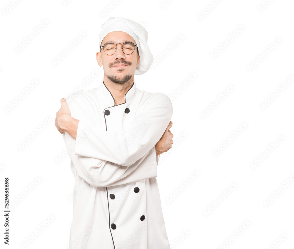 Happy young chef doing a hug gesture