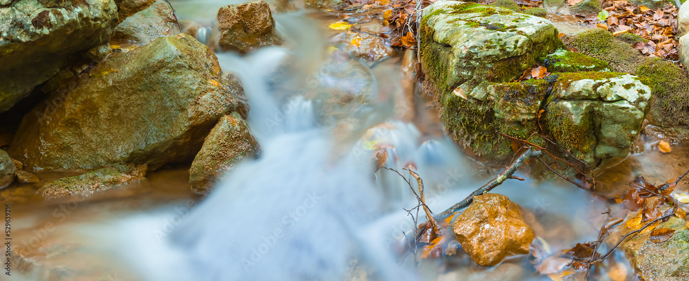 closeup small brook rushing through the mountain canyon, autumn mountain river scene closeup small brook rushing through the mountain canyon, autumn mountain river scene